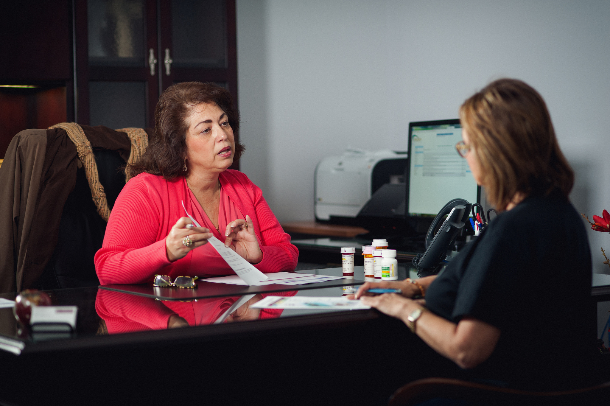 A woman goes over paperwork with a client.